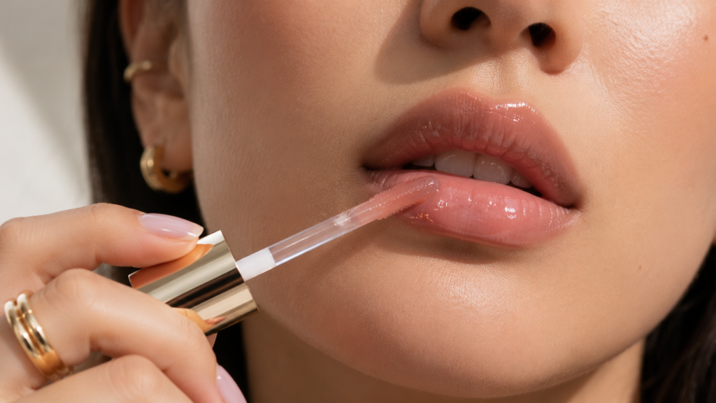 Applying nourishing lip oil for a clean minimalist beauty look
