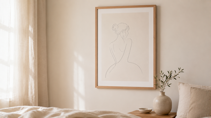 framed minimalist line art drawing on bedroom wall