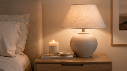 warm minimalist bedside lamp and glowing candle